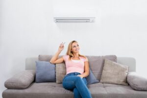 Image of a ductless system above a couch. Ductless ACs Improve Indoor Air Quality and Control Humidity.